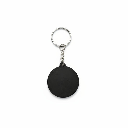 Black keychain on a textured black background
