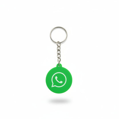Green keychain with WhatsApp logo on a dark textured background