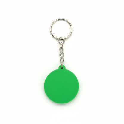 Green keychain with a metal ring on a dark textured background