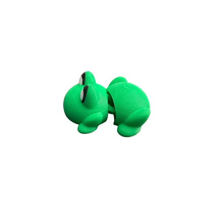 Two green turtle figurines on a wooden surface