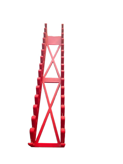 Red metal stand on a black surface with a blurred background