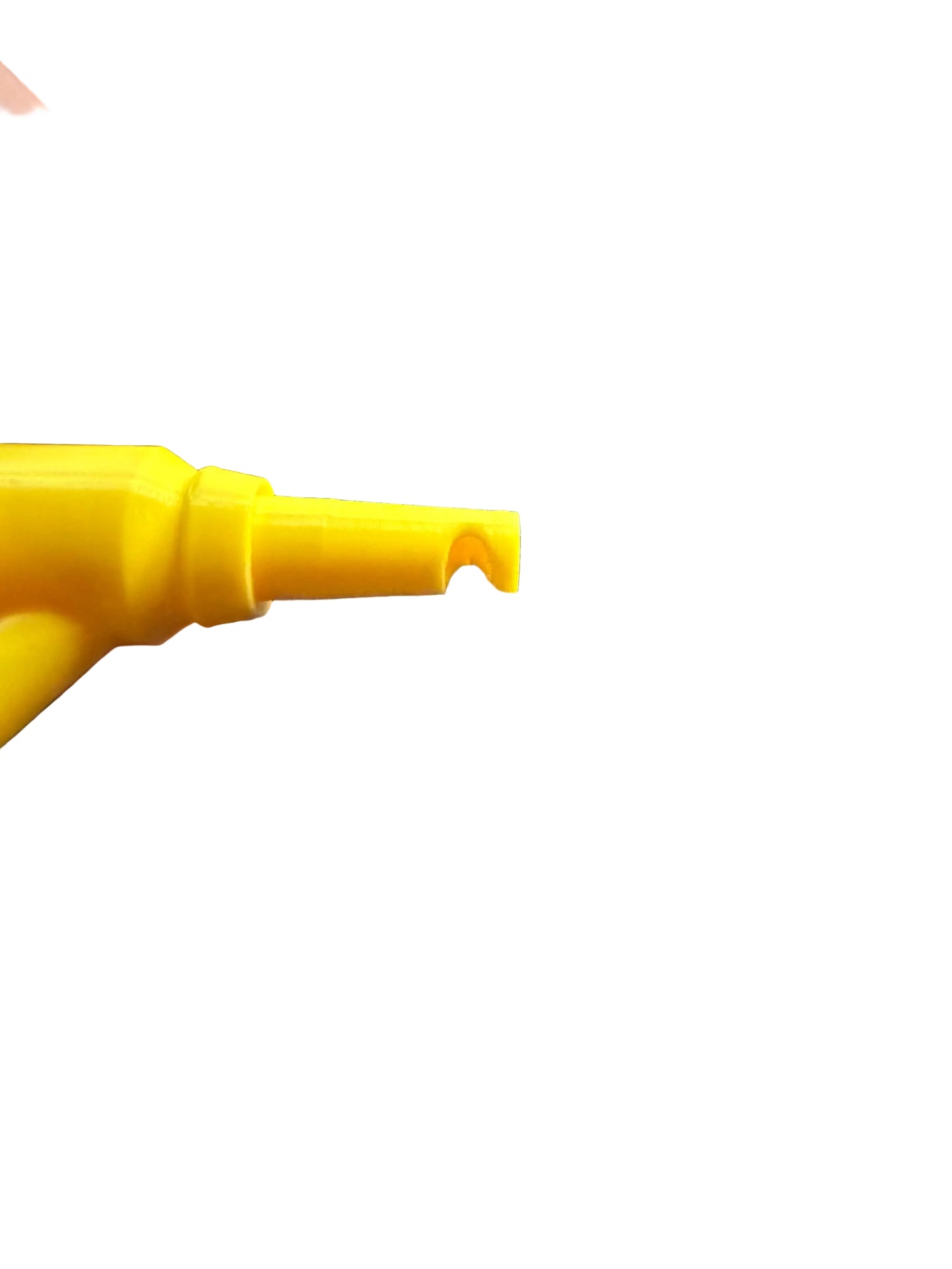 Hand holding a yellow tool on a carbon fiber surface