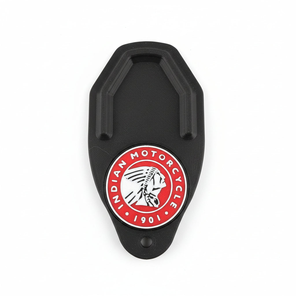 Black metal clip with Indian Motorcycle logo on a carbon fiber background