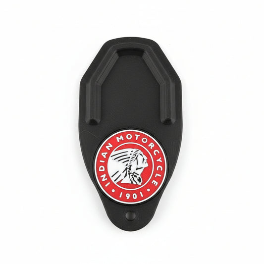 Black metal clip with Indian Motorcycle logo on a carbon fiber background