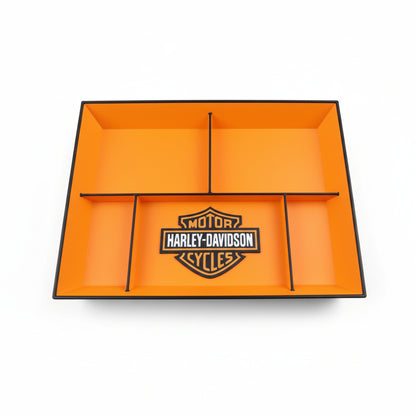 Orange tray with Harley-Davidson logo on a black surface