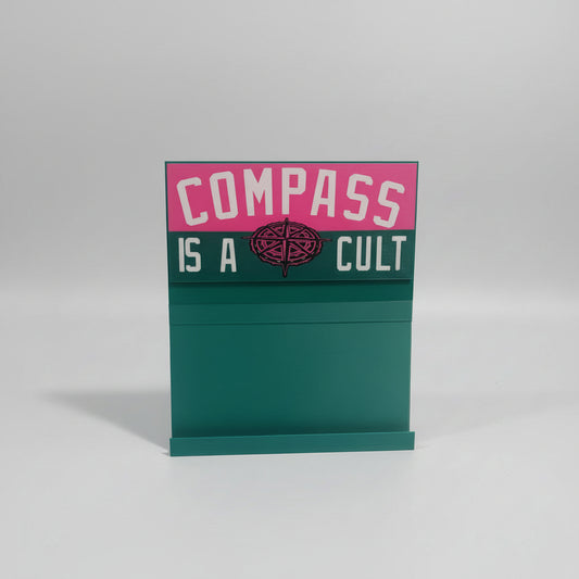 Green box with pink and white text on a marble surface