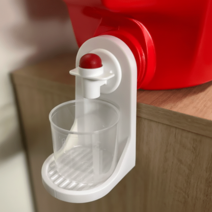 White pet water bottle holder with a red container on a wooden surface.