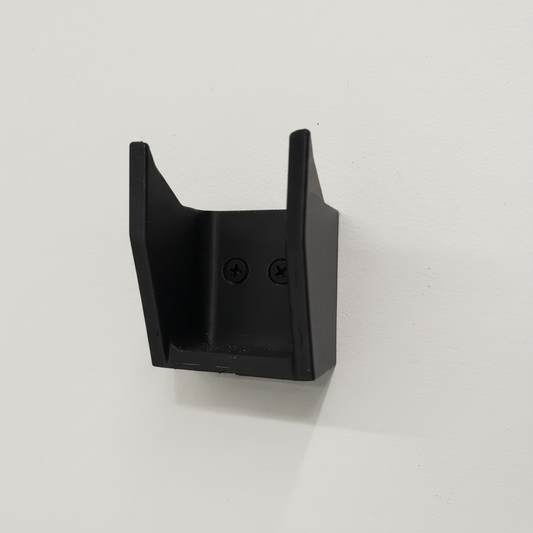 Black plastic component on a white background