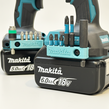 Makita drill bit set with batteries on a white background