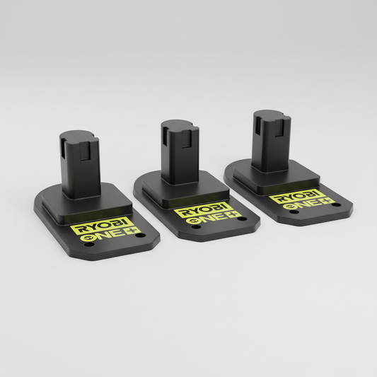 Three Ryobi ONE+ battery attachments on a wooden surface