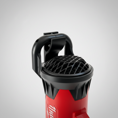 Red power washer with black nozzle attachment on a beige wall