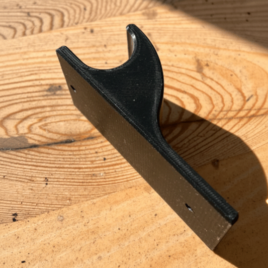 Black metal bracket on a wooden surface
