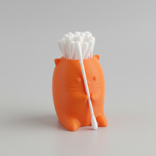 Orange cat-shaped holder with cotton swabs on a dark surface