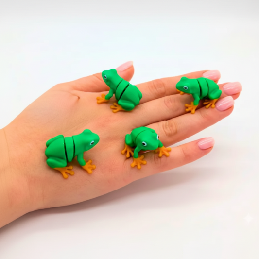 Green 'Tiny Tree Frog' toys on a hand with 'Micro Flexis' branding.