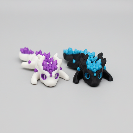 Two mini crystal dragon figurines, one purple and one black, held in a hand with 'Mini Crystal Dragon' text above.