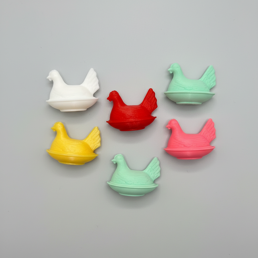 Colorful chicken-shaped objects on a dark background