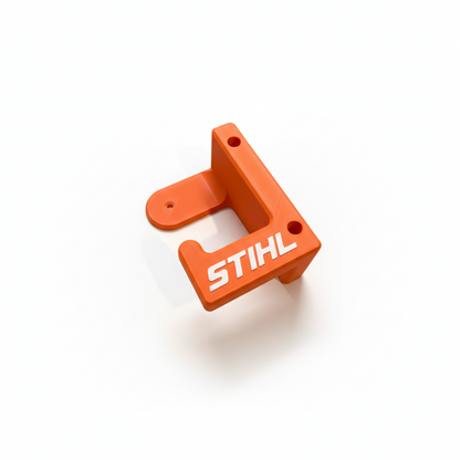 Orange metal bracket with 'STIHL' branding on a white background