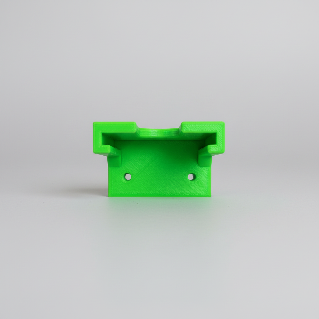 Green metal bracket on a wooden surface