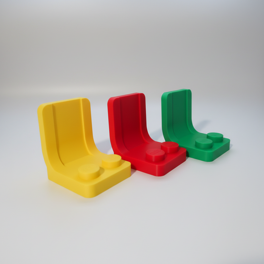 Three colorful plastic U-shaped blocks on a white surface with a gray background