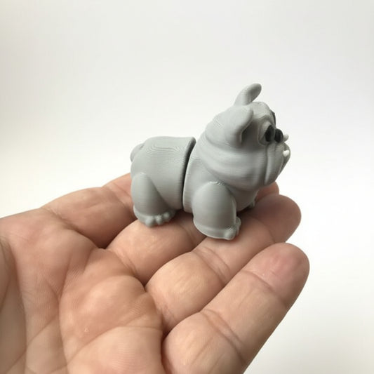 Gray rhinoceros-shaped object held in a hand on a wooden floor.