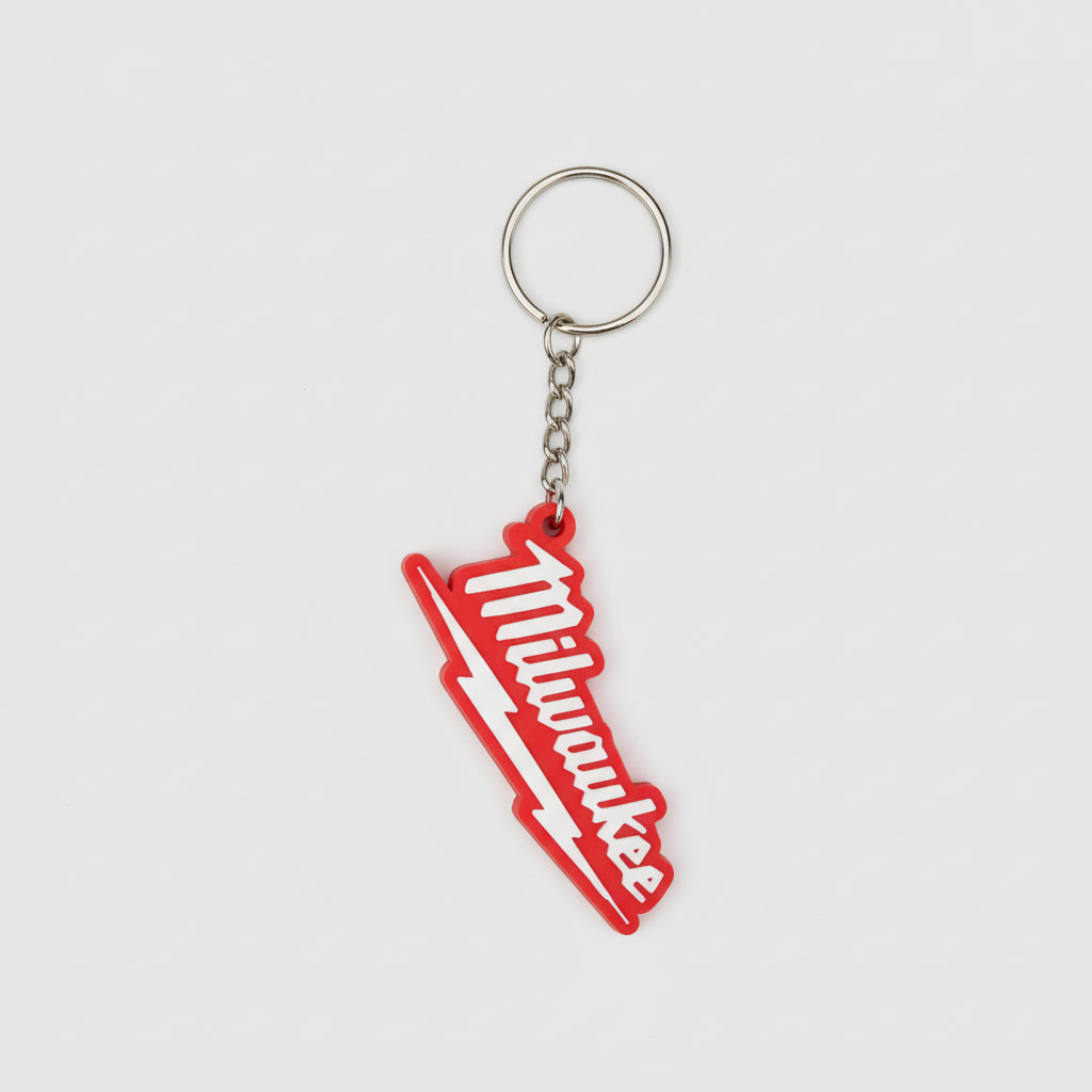Red and white 'Milwaukee' keychain on a textured gray surface