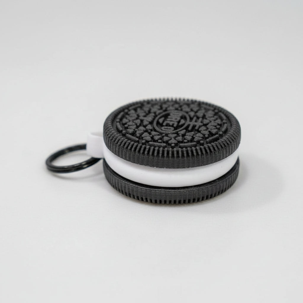 Oreo cookie-shaped keychain on a marble surface