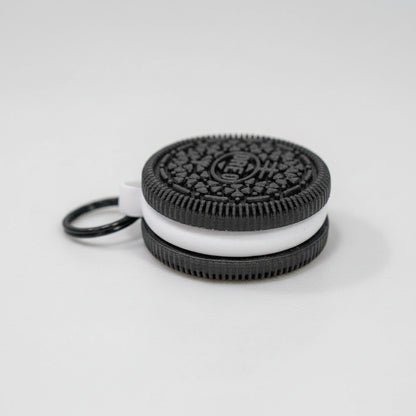 Oreo cookie-shaped keychain on a marble surface