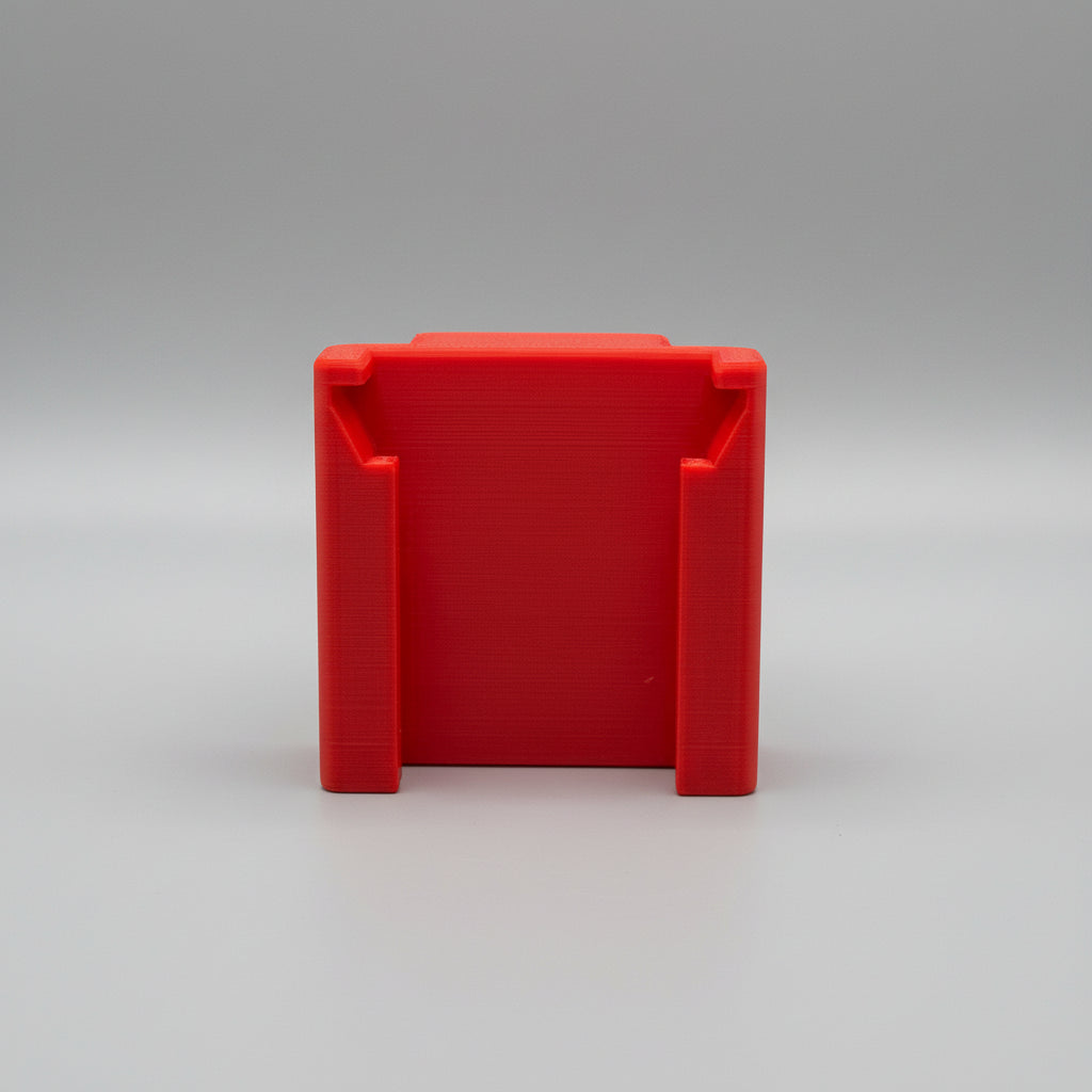 Red plastic block on a textured gray surface