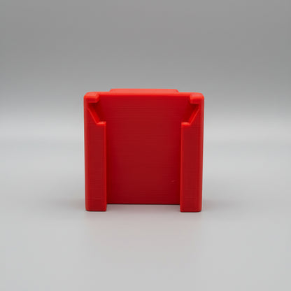Red plastic block on a textured gray surface