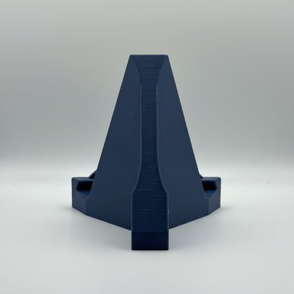 Blue plastic component on a gray background