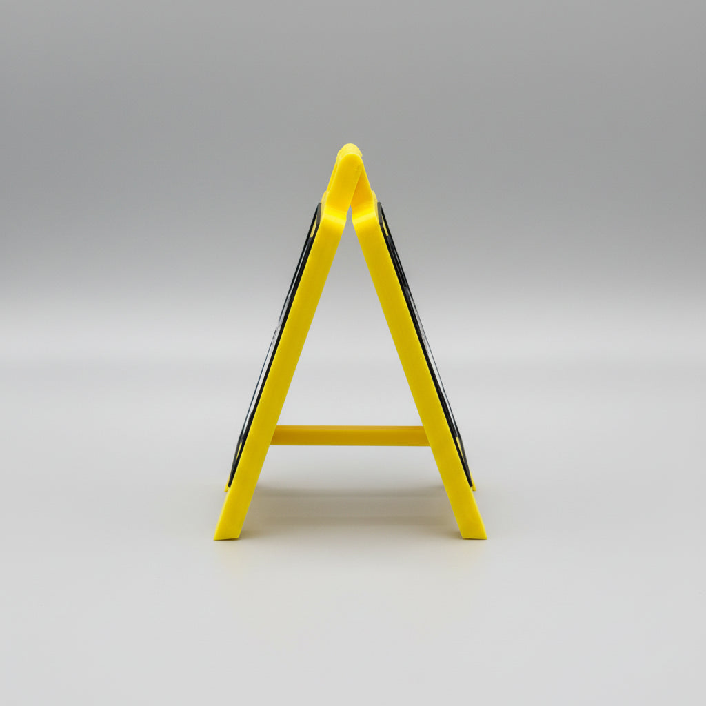 Yellow safety sign on a reflective surface
