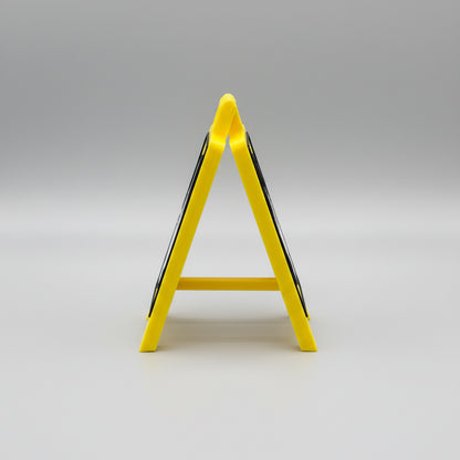 Yellow safety sign on a reflective surface