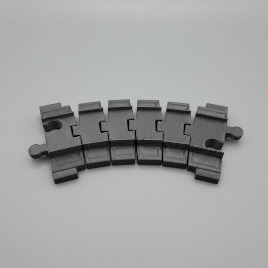 Black plastic component on a textured gray surface