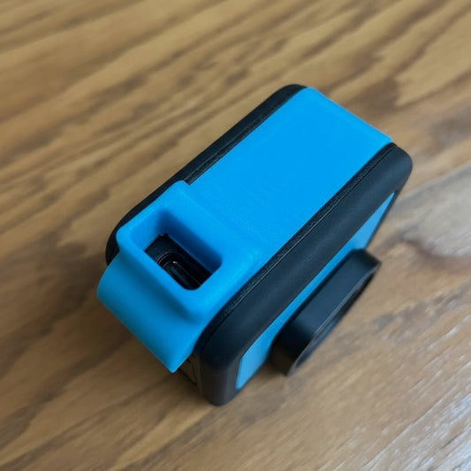 Blue and black electronic device on a wooden surface