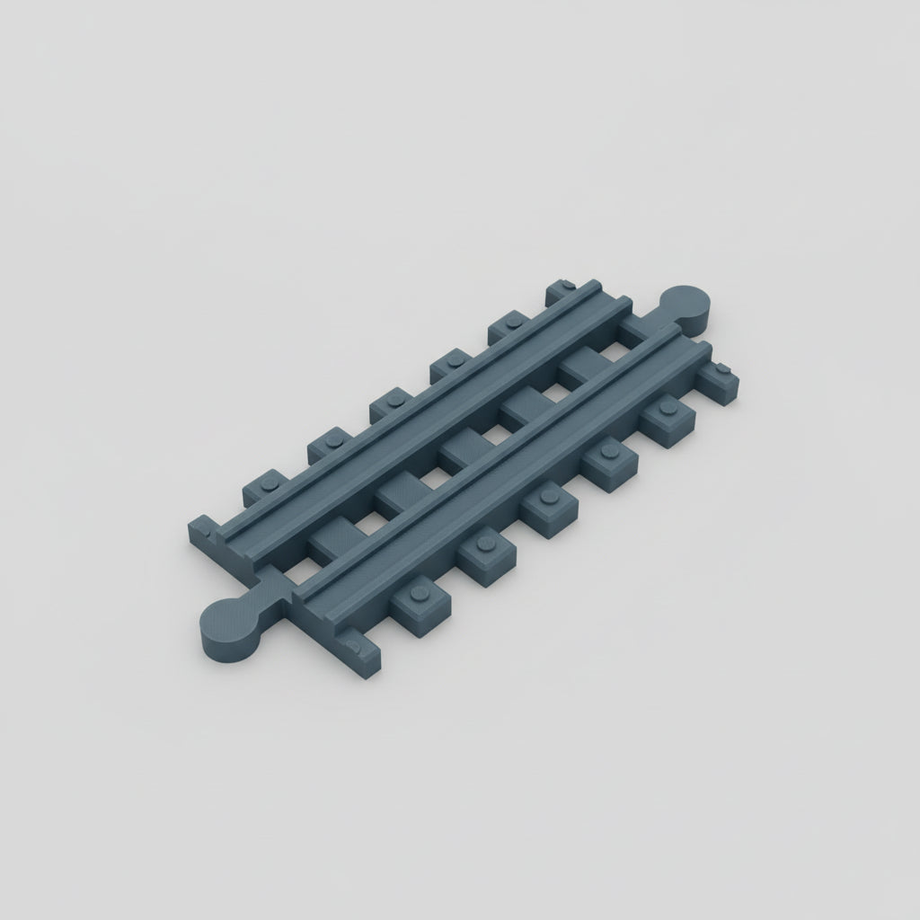 Dark gray toy train track on a textured gray surface
