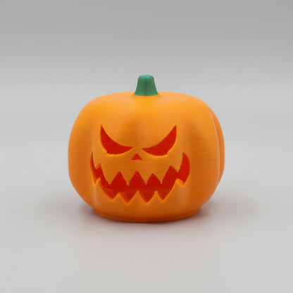 Jack-o'-lantern with a carved face on a white surface with a textured gray background