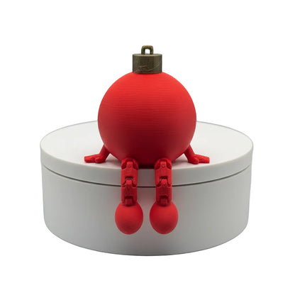 Red spherical object with legs on a white base against a textured gray background