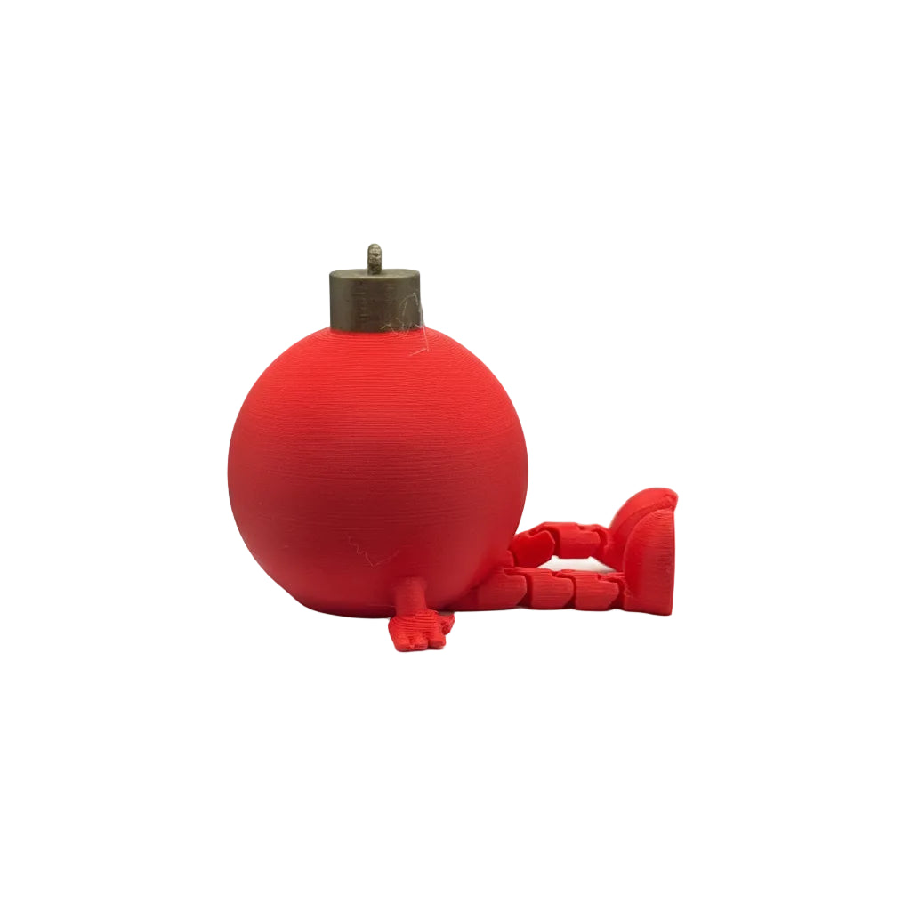 Red spherical object with a handle on a white surface against a textured gray background