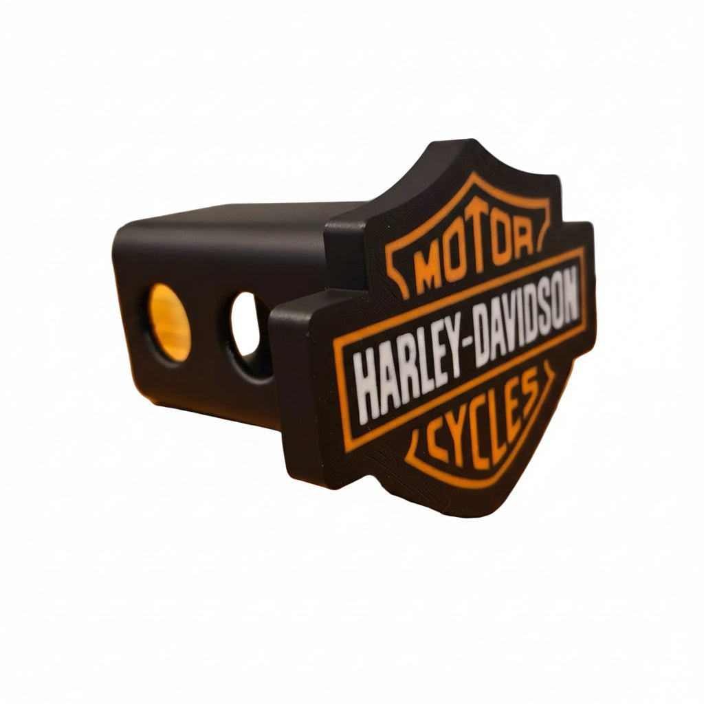 Harley-Davidson trailer hitch cover on a wooden surface