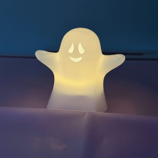Ghost-shaped night light on a dark background