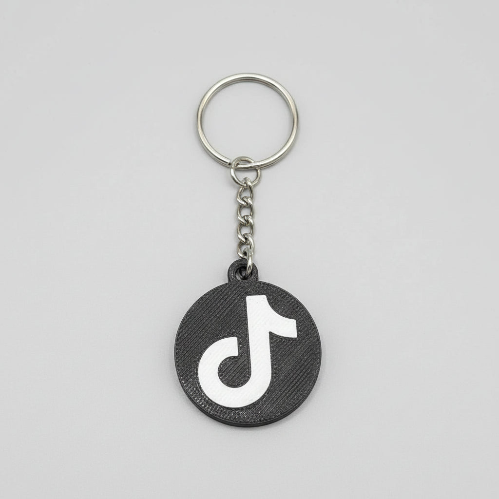 Keychain with TikTok logo on a wooden surface
