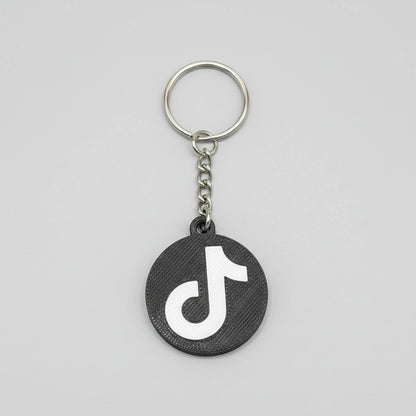 Keychain with TikTok logo on a wooden surface