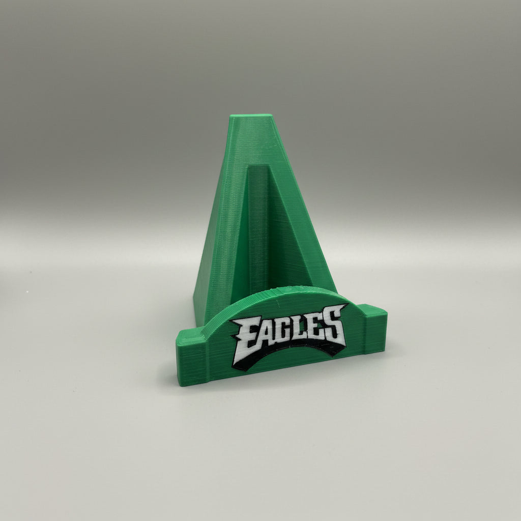 Green and blue phone stand with 'Eagles' branding on a gray background