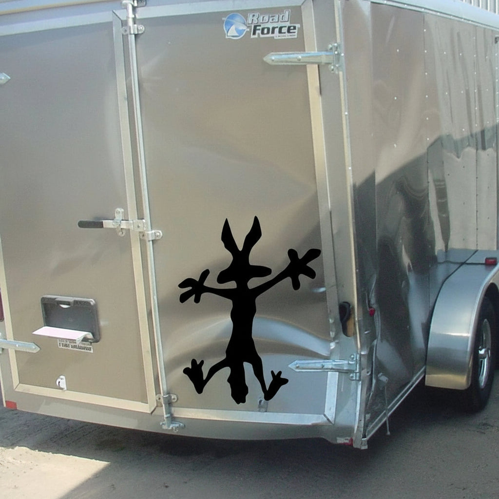 Silver trailer with a black decal of a rabbit on a concrete surface.