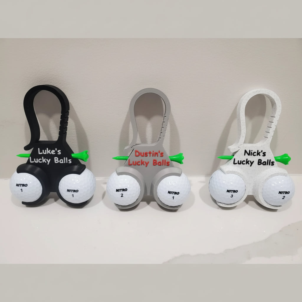 Three sets of golf balls with personalized holders on a white background