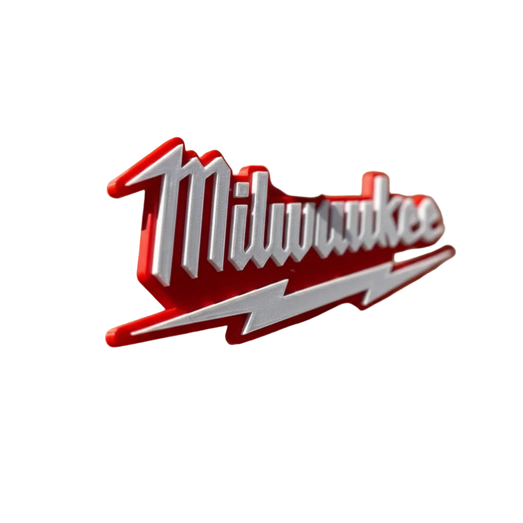 Hand holding a red and white Milwaukee logo against a brick wall.