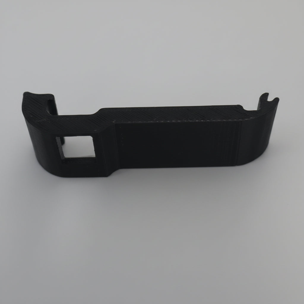 Black plastic car dashboard trim on a gray background
