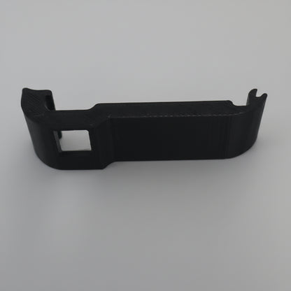 Black plastic car dashboard trim on a gray background