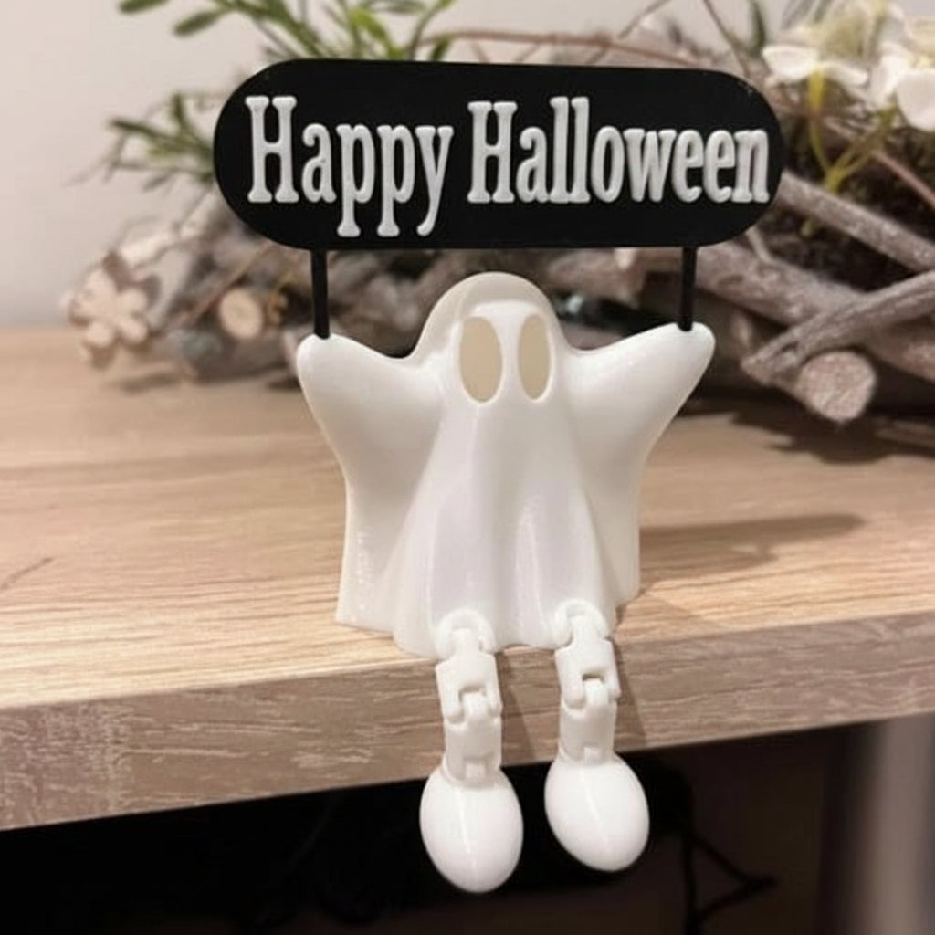 White ghost decoration with 'Happy Halloween' sign on a wooden surface