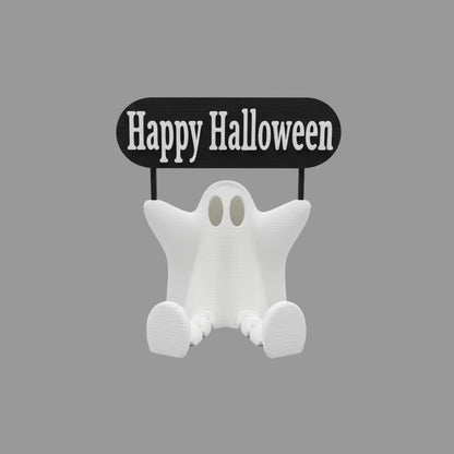 Ghost figurine with 'Happy Halloween' sign on a wooden surface